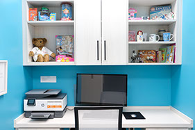 pediatric dental office workspace decorated with computer and kids toys and books 