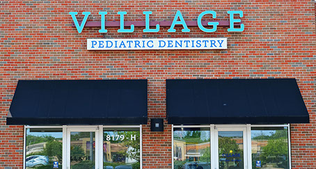 front of village pediatric dentistry's brick building