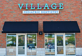 front of village pediatric dentistry's brick building
