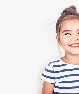 smiling girl confident about her easy visit to village pediatric dentistry